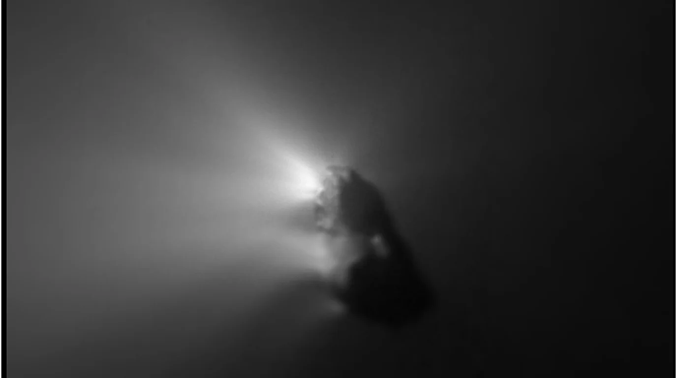 Halley's Comet nucleus close-up — dark peanut-shaped body with bright jets of gas erupting toward the Sun.